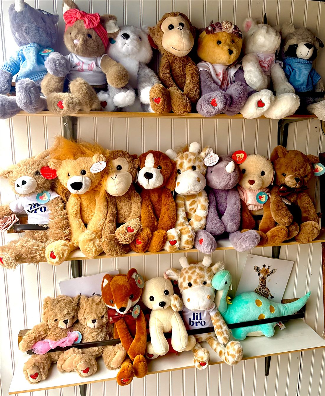 Shelves of plush animals tagged for a heartbeat recorder, including bears, a lion, a fox, a monkey and a giraffe.